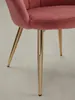 Detailaufnahme der schlanken, goldfarbenen Stuhlbeine und des Übergangs zur weich gepolsterten Sitzschale aus rosa Samtstoff._#sku_BARWL6.284# Produktbild-Vorschau