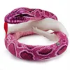 A plush pink python snake coiled around a white object, with its red tongue sticking out. Produktbild-Vorschau