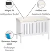 A white storage bench with a padded beige seat, shown with callouts highlighting its features. Podgląd zdjęcia produktu