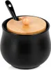 A black ceramic sugar bowl with a wooden lid and a black spoon. Produktbild-Vorschau