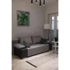 A living room scene with a sofa, a floor lamp, and a painting on the wall. A heating mat is laid out on the floor in front of the sofa. Náhled obrázku produktu