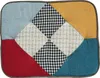 A close-up, top-down view of a patchwork cushion or seat pad. Podgląd zdjęcia produktu