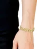 A person's arm wearing a gold bracelet. Voir les images du produit