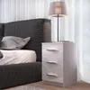 A bedside table next to a bed. Anteprima dell’immagine prodotto