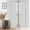 A room interior with white sheer curtains hanging over a window, a decorative basket with a towel, and dried grass in a vase. Produktbild-Vorschau