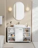 A white bathroom vanity with a sink and mirror above it, set against a beige herringbone tile wall.