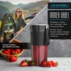 A woman is standing next to a car with a smoothie maker and strawberries in the foreground. Produktbild-Vorschau