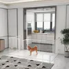 A dog is inside a white metal playpen set up in a modern living room with a kitchen visible in the background. Produktbild-Vorschau