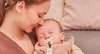 A mother holding her sleeping baby. Produktbild-Vorschau