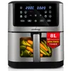 A silver and black air fryer with a transparent window showing vegetables inside, placed on a white background. Produktbild-Vorschau