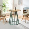 A round dining table with a pastel green base and wooden top, set in a bright room with two chairs and a window in the background. Náhľad obrázku produktu