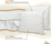 A diagram showing the layers and materials of two white pillows, with descriptive text and a brand logo. Produktbild-Vorschau