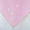 A close-up of a pink sheer fabric with a floral pattern, folded to show a corner. Produktbild-Vorschau
