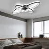 A modern bedroom with a bed, desk, and window, featuring a geometric ceiling light. Podgląd zdjęcia produktu