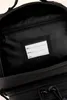Close-up view of the inside of a black backpack, showing a label for name, address, and phone number. Náhled obrázku produktu