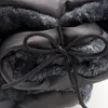 A close-up view of a folded dog blanket with a dark gray rope tie. Produktbild-Vorschau