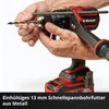 A person is holding a drill and a metal rod, demonstrating how to use the drill. Produktbild-Vorschau