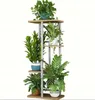 A multi-tiered plant stand with various potted plants on each level, set against a white background. Produktbild-Vorschau