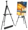 Two black easels are shown, one empty and one holding a painting of a lighthouse. A black carrying case is also visible. Produktbild-Vorschau