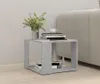A gray side table with books and decorative items on it, next to a sofa. Podgląd zdjęcia produktu