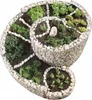 A spiral-shaped raised garden bed made of gabion stones, filled with soil and various plants. Produktbild-Vorschau