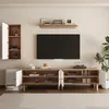 A modern living room setup featuring a wall-mounted cabinet, a TV stand with a TV, and decorative items. Produktbild-Vorschau