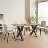 A dining table with four chairs in a well-lit room. Produktbild-Vorschau