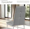 A gray upholstered dining chair with tufted back and crystal accents in a brightly lit room. Produktbild-Vorschau