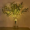 A vase of artificial olive branches with LED lights. Produktbild-Vorschau
