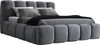 A gray upholstered bed with pillows and a blanket. Produktbild-Vorschau