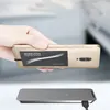 A hand holds a smartphone with a wireless charging receiver attached, positioned above a wireless charging pad. Produktbild-Vorschau