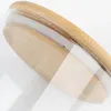 A close-up view of the lid of a glass storage jar, showing the bamboo lid and the rim of the glass jar. Produktbild-Vorschau