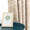 A framed picture of leaves sits on a dark teal tray in front of a tan curtain with white abstract lines. Produktbild-Vorschau