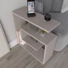 A side table next to a sofa with a phone, a glass of drink, and books. Anteprima dell’immagine prodotto