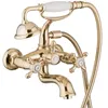 A close-up studio shot of a gold-colored bathtub faucet with a handheld shower attachment. Produktbild-Vorschau