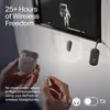 A person is holding a pair of wireless earbuds and a charging case, with a small black device plugged into a screen in the background, suggesting in-flight entertainment. Anteprima dell’immagine prodotto