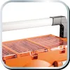 A close-up view of the top section of an orange tool case with clear plastic lids. Produktbild-Vorschau