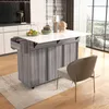 A kitchen island with an extendable countertop is shown in a modern kitchen setting, next to a window with a view of houses and trees. A chair is placed in front of the island. Anteprima dell’immagine prodotto