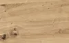 A close-up view of a wooden surface with visible grain and knots. Produktbild-Vorschau