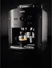 A black Krups espresso machine is shown in a studio setting with a dark background. Podgląd zdjęcia produktu