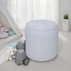 A white, fluffy ottoman sits on a light-colored floor in a child's room, next to a teepee and some toys. Náhled obrázku produktu