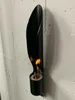A black ethanol fireplace mounted on a white brick wall. Produktbild-Vorschau