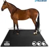 A brown horse standing on a black rubber mat. Produktbild-Vorschau
