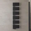 A black radiator mounted on a textured gray wall. Produktbild-Vorschau