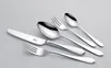 A set of silverware, including a knife, two spoons, and two forks, is arranged on a light gray background. Produktbild-Vorschau