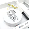A close-up view of an LED driver and its wiring, placed within a white metal fixture. Podgląd zdjęcia produktu