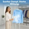 A woman is using a garment steamer on a blue shirt in a closet setting. Náhled obrázku produktu