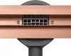 A close-up view of a shower drain with a copper frame and a gray grate. Anteprima dell’immagine prodotto