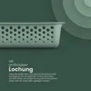 A close-up of a green storage basket with holes, with text describing its features. Produktbild-Vorschau