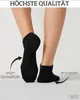 A close-up view of a person's legs and feet wearing black socks, with informational text and arrows pointing to features. Produktbild-Vorschau